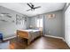 Comfortable bedroom with a ceiling fan, wood floors, and natural light from the window at 1808 Stonecrest Ct, Lakeland, FL 33813