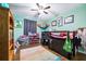 Bright bedroom with hardwood floors, a ceiling fan, and ample space for a bed and storage at 1808 Stonecrest Ct, Lakeland, FL 33813