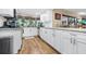 Bright kitchen features white cabinetry, stainless steel appliances, granite counters, and a garden window at 1808 Stonecrest Ct, Lakeland, FL 33813