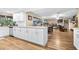 Spacious kitchen with expansive granite countertops, white cabinets, stainless dishwasher, and an open floor plan at 1808 Stonecrest Ct, Lakeland, FL 33813