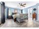 Spacious main bedroom with a ceiling fan, a tiled floor, and bathroom access at 1808 Stonecrest Ct, Lakeland, FL 33813