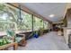 Enclosed patio with abundant natural light, hanging plants, and ample seating at 1808 Stonecrest Ct, Lakeland, FL 33813