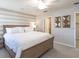 Cozy bedroom featuring a wood bed frame, striped accent wall, ceiling fan, and neutral carpet at 1809 Noble Dr, Davenport, FL 33837