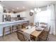 Open dining area featuring a dining table set for a meal with a view of the kitchen and stainless steel appliances at 1809 Noble Dr, Davenport, FL 33837