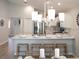 Open-concept kitchen with island seating, stainless steel appliances, modern chandelier, and white cabinets at 1809 Noble Dr, Davenport, FL 33837