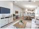 Inviting living room with wood-look flooring, a neutral sofa, a flat-screen TV, and an open floor plan at 1809 Noble Dr, Davenport, FL 33837