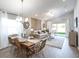 Open-concept living space featuring a dining area and comfortable seating arrangement at 1809 Noble Dr, Davenport, FL 33837