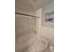 Bathroom featuring a white tiled tub with shower head, white toilet and a painting at 1809 Optimist Dr, Lakeland, FL 33801