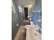 Bathroom featuring a large mirror, towel racks, and a white tiled floor at 1809 Optimist Dr, Lakeland, FL 33801