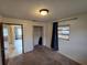 Bedroom featuring a window, closet and a view of an adjacent room from the open doorway at 1809 Optimist Dr, Lakeland, FL 33801