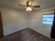 Bedroom featuring neutral carpet, ceiling fan with lights, and a window at 1809 Optimist Dr, Lakeland, FL 33801