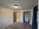Bedroom featuring a window, closet and a view of an adjacent room from the open doorway at 1809 Optimist Dr, Lakeland, FL 33801