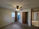 Bedroom featuring neutral carpet, ceiling fan with lights, a window, and closet at 1809 Optimist Dr, Lakeland, FL 33801