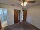 Bedroom featuring neutral carpet, ceiling fan with lights, and a closet at 1809 Optimist Dr, Lakeland, FL 33801