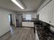 Well-equipped kitchen featuring stainless steel appliances, elegant countertops, and vinyl flooring at 1809 Optimist Dr, Lakeland, FL 33801