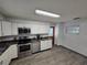 Modern kitchen with stainless steel appliances, ample cabinet space, and stylish flooring at 1809 Optimist Dr, Lakeland, FL 33801