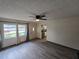 Open living room with large windows, modern flooring, and natural light, perfect for entertaining at 1809 Optimist Dr, Lakeland, FL 33801