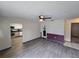 Spacious living room with modern flooring, ceiling fan, and easy access to the kitchen at 1809 Optimist Dr, Lakeland, FL 33801