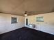 Enclosed porch with concrete flooring, ceiling fan, and swing; creating a cozy outdoor space at 1809 Optimist Dr, Lakeland, FL 33801