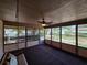 Screened-in porch with dark floor, swing, and windows; perfect for enjoying the outdoors comfortably at 1809 Optimist Dr, Lakeland, FL 33801