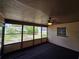 Bright screened-in porch with a fan, offering a relaxing space with views of the yard at 1809 Optimist Dr, Lakeland, FL 33801