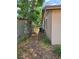 Exterior view of side yard with AC unit, showing property boundary and maintenance area at 1809 Optimist Dr, Lakeland, FL 33801