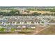Aerial view showcasing new construction homes in a neighborhood with green spaces and a mix of brown and blue roofs at 1821 Thompson Preserve Boulevard, Bartow, FL 33830