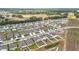 New construction homes line the street in this aerial view with green space and ponds throughout the community at 1821 Thompson Preserve Boulevard, Bartow, FL 33830