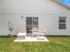 Patio with outdoor furniture on a green lawn with a sliding glass door at 1821 Thompson Preserve Boulevard, Bartow, FL 33830