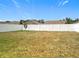Spacious backyard with lush green grass and a white privacy fence at 1821 Thompson Preserve Boulevard, Bartow, FL 33830