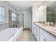 Spacious bathroom featuring a soaking tub, glass-enclosed shower, and double vanity at 1821 Thompson Preserve Boulevard, Bartow, FL 33830