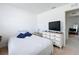 Cozy bedroom with a comfortable bed, dresser with TV, and a neutral color scheme at 1821 Thompson Preserve Boulevard, Bartow, FL 33830