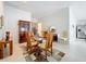 Elegant dining room features a glass table and a decorative china cabinet for a formal dining experience at 1821 Thompson Preserve Boulevard, Bartow, FL 33830