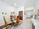 Bright dining room showcases a glass table, china cabinet, and neutral decor at 1821 Thompson Preserve Boulevard, Bartow, FL 33830