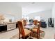 Open-concept dining room adjacent to living room with glass table, perfect for entertaining at 1821 Thompson Preserve Boulevard, Bartow, FL 33830