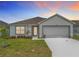 Charming single-story home boasts a manicured lawn and two-car garage at 1821 Thompson Preserve Boulevard, Bartow, FL 33830