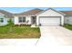 Inviting single-story home features a well-maintained lawn and a two-car garage at 1821 Thompson Preserve Boulevard, Bartow, FL 33830