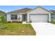 Inviting single-story home features a well-maintained lawn and a two-car garage at 1821 Thompson Preserve Boulevard, Bartow, FL 33830