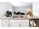 Kitchen island with sink and seating, offering a view into the living and dining areas at 1821 Thompson Preserve Boulevard, Bartow, FL 33830
