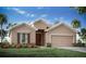 Charming single-story home featuring a 2-car garage, well-manicured lawn, and beautiful landscaping at 1833 Noble Dr, Davenport, FL 33837