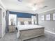 Cozy bedroom with a comfortable king bed, ceiling fan, and stylishly painted accent wall and décor at 1837 Noble Dr, Davenport, FL 33837