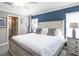 Bright bedroom features a large bed, stylish decor, and ample natural light from the windows at 1837 Noble Dr, Davenport, FL 33837