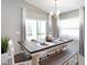 Cozy dining room featuring a stylish table setting, ample natural light, and modern chandelier at 1837 Noble Dr, Davenport, FL 33837