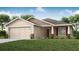 Charming single-story home featuring a two-car garage, well-manicured lawn, and inviting front entrance at 1837 Noble Dr, Davenport, FL 33837