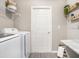 Convenient laundry room featuring a washer and dryer, complemented by stylish décor and ample storage space at 1837 Noble Dr, Davenport, FL 33837