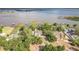 Breathtaking aerial view of a lakeside home with lush greenery, a pool, and stunning water views at 2070 W Lake Hamilton Dr, Winter Haven, FL 33881