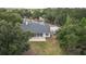 Aerial view of a secluded home surrounded by lush trees and greenery at 2070 W Lake Hamilton Dr, Winter Haven, FL 33881