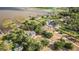Stunning aerial shot of the sprawling estate with lush landscaping, lake frontage, and multiple outbuildings at 2070 W Lake Hamilton Dr, Winter Haven, FL 33881