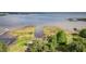Scenic aerial view of the waterfront property featuring lush greenery and a serene lake at 2070 W Lake Hamilton Dr, Winter Haven, FL 33881