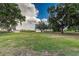 Spacious backyard featuring lush green grass, mature trees, and beautiful landscaping at 2070 W Lake Hamilton Dr, Winter Haven, FL 33881